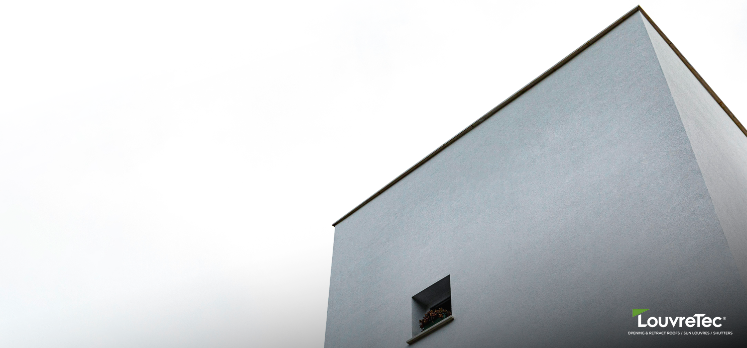 Minimalist building façade with a single recessed window, illustrating sleek lines inspired by Sun Louvre Collections