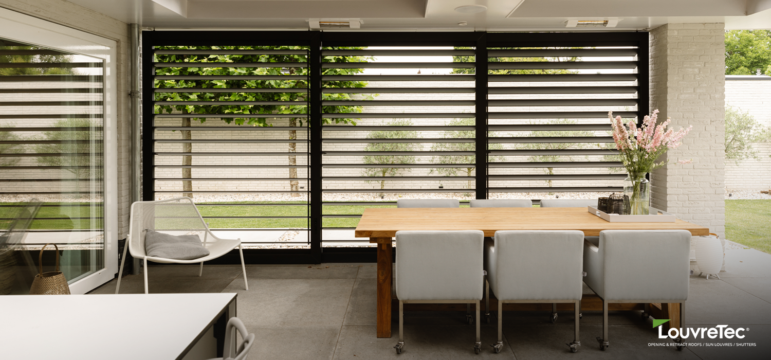 Outdoor dining space enclosed with horizontal sun louvre screens from the Sun Louvre Collections, providing privacy and adjustable airflow