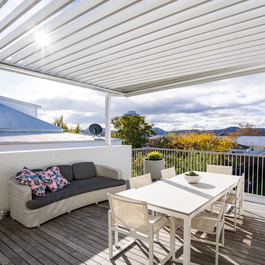 Motorised louvre roof over a modern outdoor entertaining area.