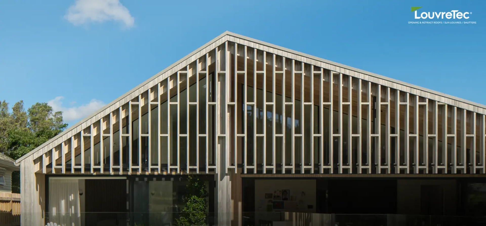Modern home façade featuring Louvretec vertical rectangular sun louvres, designed to provide privacy and solar control while adding structural character