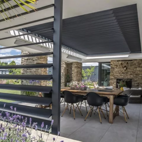 Covered patio with adjustable louvred roof and side screens, showing how louvred roofs provide shade, airflow control and weather protection for year round outdoor living.