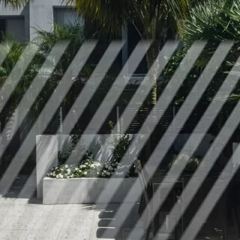 An outdoor patio with chairs and outdoor blinds